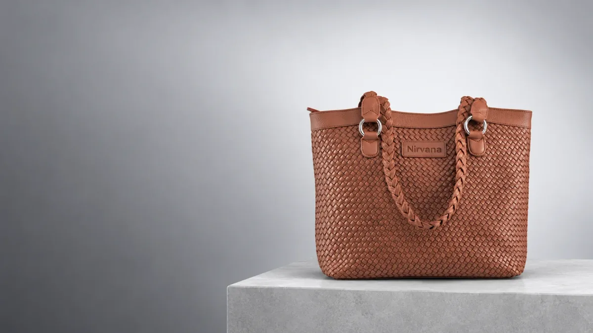 Nirvana handwoven leather tote on a limestone plinth
